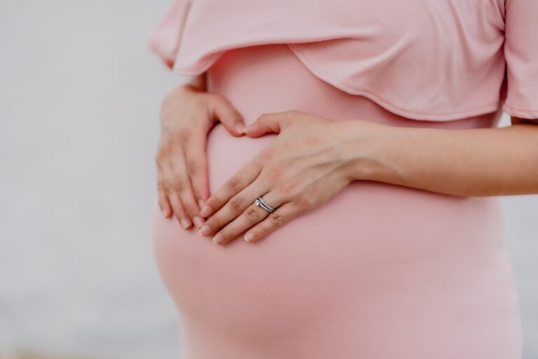 pregnant woman holding her stomach