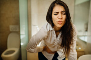 woman in severe pain in the bathroom