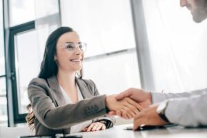 woman shaking hands with man in white coat